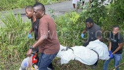 Police officer and funeral home staff remove Jelani John's body from the scene in Fairbaine Pasture on Saturday, Nov. 16, 2024.