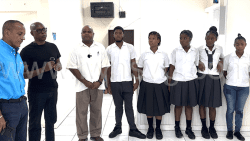 From left: Keith Boyea and Andre Iton of MRI6, Principal of Union Island Secondary School, Darrel Williams and students of the school during the presentation at Arnos Vale on Thursday, Nov. 14, 2024. 