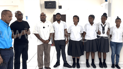 From left: Keith Boyea and Andre Iton of MRI6, Principal of Union Island Secondary School, Darrel Williams and students of the school during the presentation at Arnos Vale on Thursday, Nov. 14, 2024. 