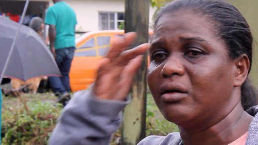 Yambout resident, Gillian Bascombe cries during an interview with iWitness News on Nov. 19, 2024 as a the Yambou River threatened to claim her house.