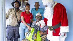 Joyce Williams, who lost her home to Hurricane Beryl, receives a package from the Rubis team.