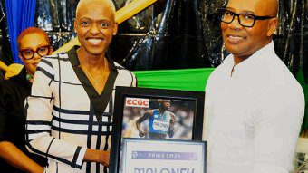 Shafiqua Maloney, left, presents J. Robert Cato, CEO of ECGC with an Olympic bib and autographed photo at the “The Inspiration” Fundraiser on March 8, 2025. 