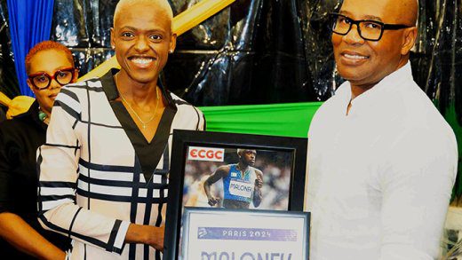 Shafiqua Maloney, left, presents J. Robert Cato, CEO of ECGC with an Olympic bib and autographed photo at the “The Inspiration” Fundraiser on March 8, 2025. 