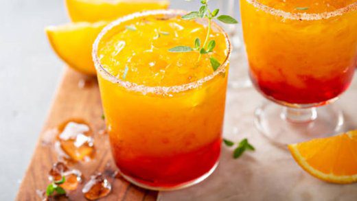 Tequila sunrise margarita cocktail in different glasses with ice, refreshing summer drink