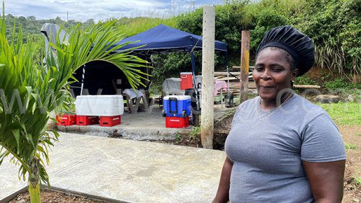 Food vendor Janella Charles in the area across the road from the entrance to Argyle International Airport on Oct. 26, 2022, when efforts were being made to stop her from vending there.
