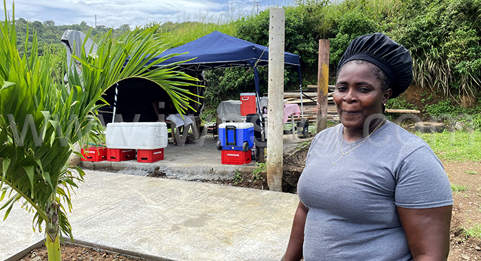 Food vendor Janella Charles in the area across the road from the entrance to Argyle International Airport on Oct. 26, 2022, when efforts were being made to stop her from vending there.