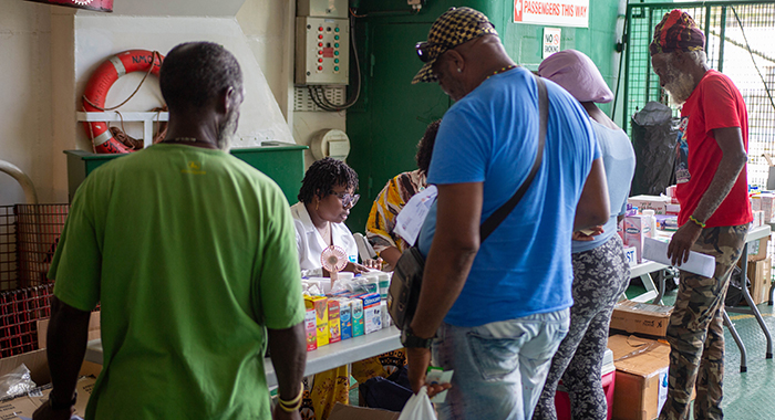 Residents of Union Island collect free prescriptions aboard after consultations with the medical team during the Rotary Village Doctor outreach.