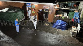 Homicide investigator process the scene of the triple homicide in Belmont on Friday, May 16, 2025. 