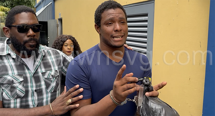 Murder Kesroy Ryan, right, is escorted from the Serious Offences Court in Kingstown by detective Station Sergeant Biorn Duncan on May 26, 2025.