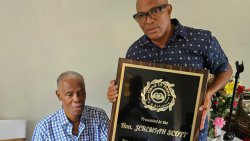 South Leeward MP, Nigel "Nature" Stephenson, right, presents a plaque to former MP, Jeremiah "Jerry" Scott. 
