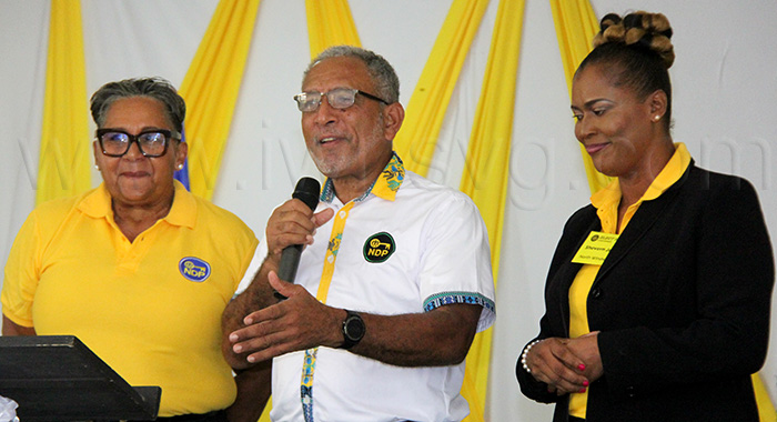 New Democratic Party women politicians, Laverne Gibson-Velox, left, and Senator Shevern John, right, with party Leader Godwin Friday at an International Women's Day event on March 8, 2025.