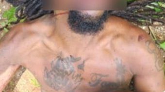 The tattoos on the chest of the unidentified body.