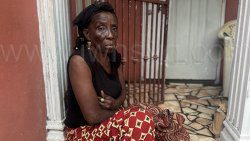 Mary Gloster, the mother of Shernard Gloster, who was allegedly shot and killed by an on-duty security guard Wadie Simon, inside the headquarters of Kingstown Co-Operative Credit Union, on Granby Street, Kingstown, sits outside her home in Glebe Hill, Barrouallie, on Friday, July 11, 2025. 