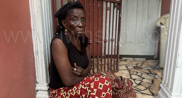 Mary Gloster, the mother of Shernard Gloster, who was allegedly shot and killed by an on-duty security guard Wadie Simon, inside the headquarters of Kingstown Co-Operative Credit Union, on Granby Street, Kingstown, sits outside her home in Glebe Hill, Barrouallie, on Friday, July 11, 2025. 