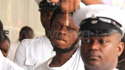 Murderer Tevin Bobb makes an obscene gesture as he led back to prison on July 4, 2025.