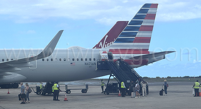 Passengers disembark from an American Airlines aircraft in Barbados on Sunday, Oct. 5, 2025.