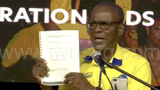 Daniel Cummings, the opposition spokesperson on healthcare and the incumbent MP for West Kingstown, holds up what he said is a copy of the Arnos Vale hospital consultancy contract that the government signed with Hospital Administrator Grace Walters at the NDP's rally in North Union on Saturday, Nov. 8, 2025.