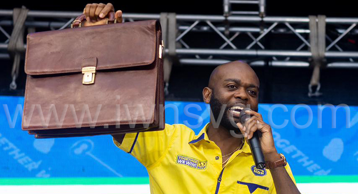 New Democratic Party candidate for North Leeward, Kishore Shallow, holds up a brief bag, which he said contains files on members of the ruling Unity Labour Party, at the NDP's rally in Biabou on Nov. 1, 2025. (Photo: NDP)