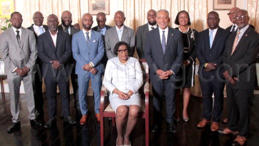 Governor General Dames Susan Dougan, seated, with Prime Minister Godwin Friday to her left, and other members of the New Democratic Party, including some candidates who were elected in the general election on Thursday, Nov. 27, 2025. 