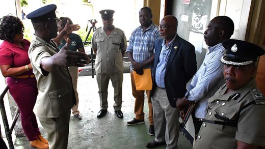Minister of National Security, St. Clair Leacock, third from right, MP for Central Leeward, Conroy Huggins and other police and national security officials listen as Commissioner of Police Enville Williams makes a point during a tour of police stations in Central Leeward on Thursday, Dec. 19, 2025. (Photo: Facebook/RSVG Police Force)