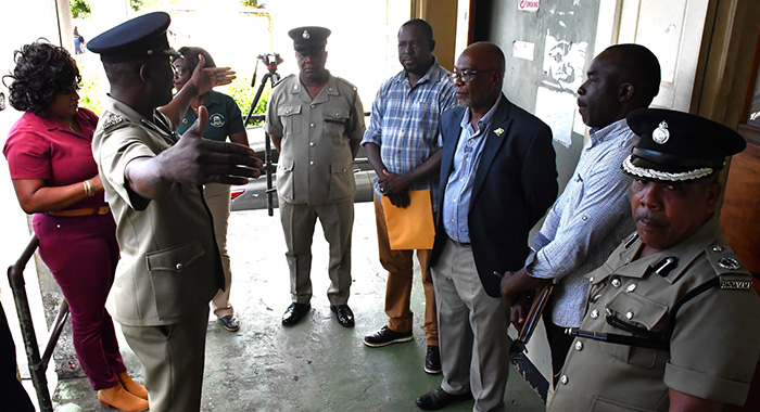 Minister of National Security, St. Clair Leacock, third from right, MP for Central Leeward, Conroy Huggins and other police and national security officials listen as Commissioner of Police Enville Williams makes a point during a tour of police stations in Central Leeward on Thursday, Dec. 19, 2025. (Photo: Facebook/RSVG Police Force)