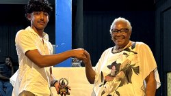 Joan Simmons, right, presenting the award to Kai Marks Dasent.