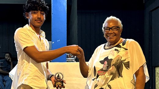 Joan Simmons, right, presenting the award to Kai Marks Dasent.