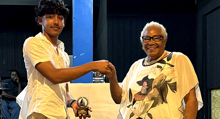 Joan Simmons, right, presenting the award to Kai Marks Dasent.