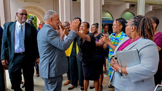 Public servants greet Prime Minister Godwin Friday as he arrived at the Administrative Complex on Monday, Dec. 1, 2025. (Photo: Facebook/API)