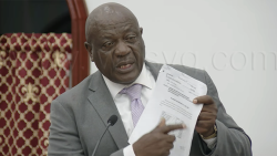 Housing Minister Andrew John holds up a Cabinet document as he debates the Estimates in Parliament on Thursday, Jan. 29, 2026.