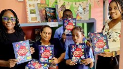 Cherry-Ann Pompey-Delpeche, left, during a donation of books to Evesham Methodist School.