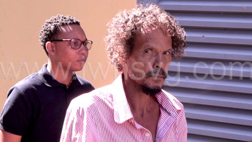 The accused, Emmanuel Matthews, 59, in police custody outside the Serious Offences Court in Kingstown on Wednesday, Dec. 31, 2025. 