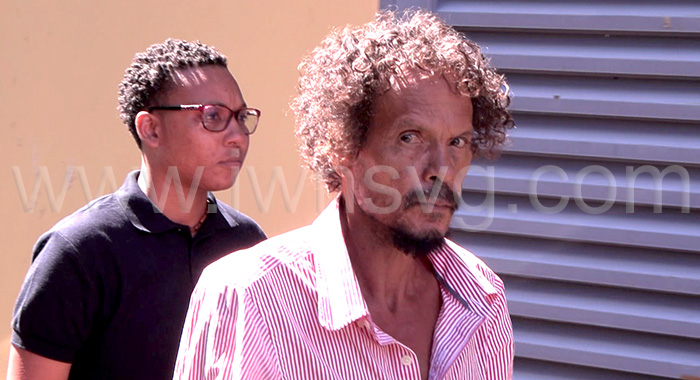 The accused, Emmanuel Matthews, 59, in police custody outside the Serious Offences Court in Kingstown on Wednesday, Dec. 31, 2025. 