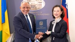 Taiwan Ambassador to St. Vincent and the Grenadines (SVG) Fiona Huei-Chun Fan, left, makes the presentation to Prime Minister of SVG, Godwin Friday. 