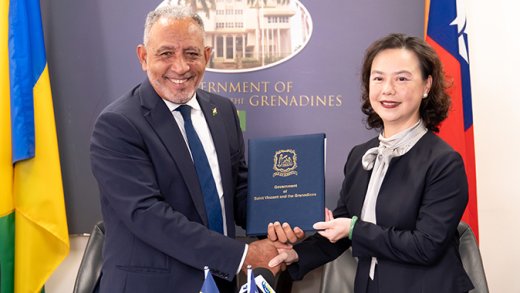 Taiwan Ambassador to St. Vincent and the Grenadines (SVG) Fiona Huei-Chun Fan, left, makes the presentation to Prime Minister of SVG, Godwin Friday. 
