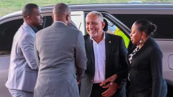 Prime Minister of St. Vincent and the Grenadines, Godwin Friday, second from right, is greeted in St. Kitts and Nevis.