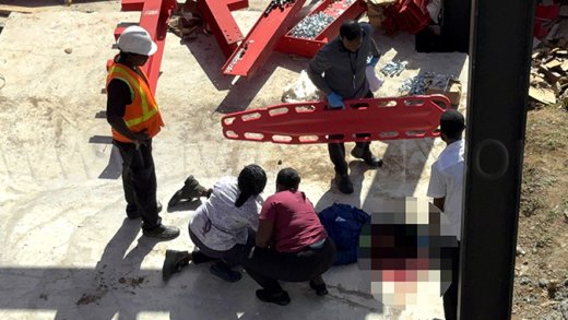 An ambulance crew attends to construction worker Lemone Baptiste after he fell from a four-storey steel frame where a building is being construction in Villa on Wednesday, Feb. 4, 2026.