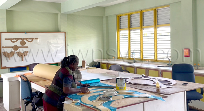 A member of Blondie Bird and Friends works on the mas band’s 2026 presentation on Saturday, March 28, 2026, one week after production began at the Thomas Saunders Secondary School campus in Kingstown.