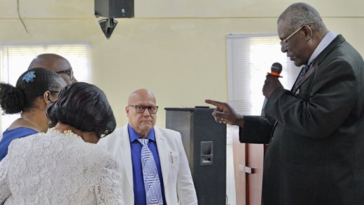 The Reverend Chiefton Charles prays for the Chances at the commissioning and send-off service at the Rillan Hill Church of the Nazarene on Feb. 22, 2026. 
