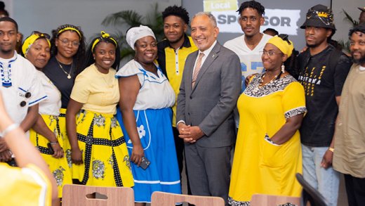 Prime Minister Godwin Friday (in suit) and Garifuna visiting St. Vincent and the Grenadines for Heroes' Day celebrations. (Photo: Facebook/API)