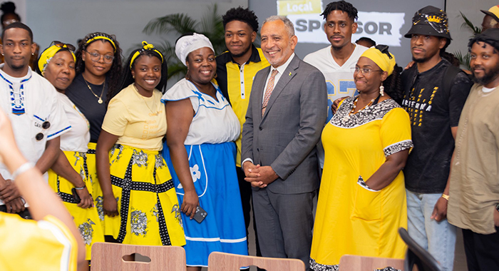 Prime Minister Godwin Friday (in suit) and Garifuna visiting St. Vincent and the Grenadines for Heroes' Day celebrations. (Photo: Facebook/API)
