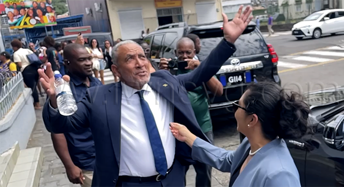 Prime Minister Godwin Friday gestures and comments about the beautiful weather outside the High Court in Kingstown on Thursday, March 5, 2026, after a hearing in an election petition challenging his election in the Nov. 27, 2025, general election. 