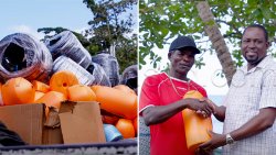 Minister of Fisheries, Conroy Huggins, right, hands over some of the items in Barrouallie. 