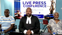 Lawyer and Senator Carlos James, centre, and police shooting victim Louis Mercury, right, and Anesta Harris-Robinson, mother of Kenton Harris, who police were filmed beating in Kingstown.