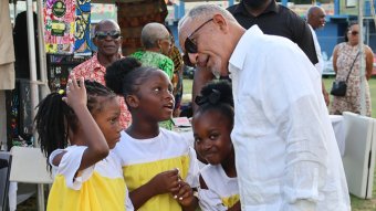 Prime Minister Godwin Friday interacts with children at the Emancipation Day event at Independence Park in Kingstown on Saturday, Aug. 1, 2026. 