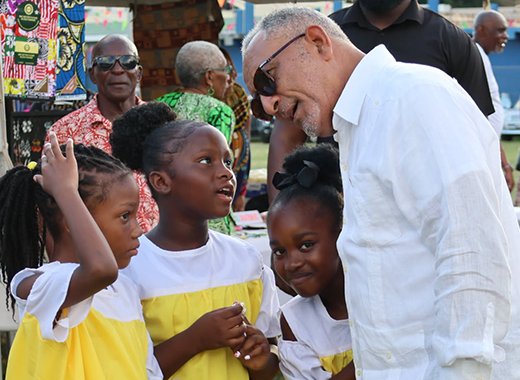 Prime Minister Godwin Friday interacts with children at the Emancipation Day event at Independence Park in Kingstown on Saturday, Aug. 1, 2026. 