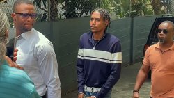 Murder accused Rhyse Henry in police custody outside the Serious Offences Court in Kingstown on Thursday, Aug. 6, 2026. 