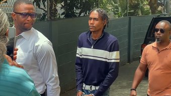 Murder accused Rhyse Henry in police custody outside the Serious Offences Court in Kingstown on Thursday, Aug. 6, 2026. 