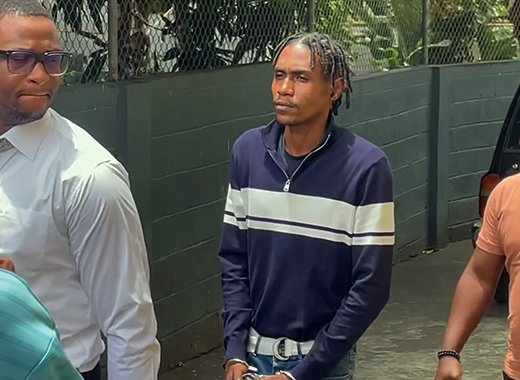 Murder accused Rhyse Henry in police custody outside the Serious Offences Court in Kingstown on Thursday, Aug. 6, 2026. 
