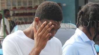 Teen killer Tyshaun Spring hides his face as he is led back to prison on July 24, 2026, to complete his sentence for murder. 